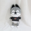 A gray and black cartoon animal plush toy with large ears and a black shirt featuring red and white graphics.