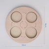 A wooden learning set with five circular cutouts for an animal and plant life cycle activity.