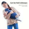 A woman is holding a baby in an all-season multi-position baby carrier sling.