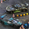 A black and green high-speed remote control drift racing car is shown on a gray surface with traffic cones.