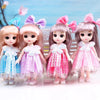 Four pink and purple articulated princess dolls with dresses and bows standing in a light setting.