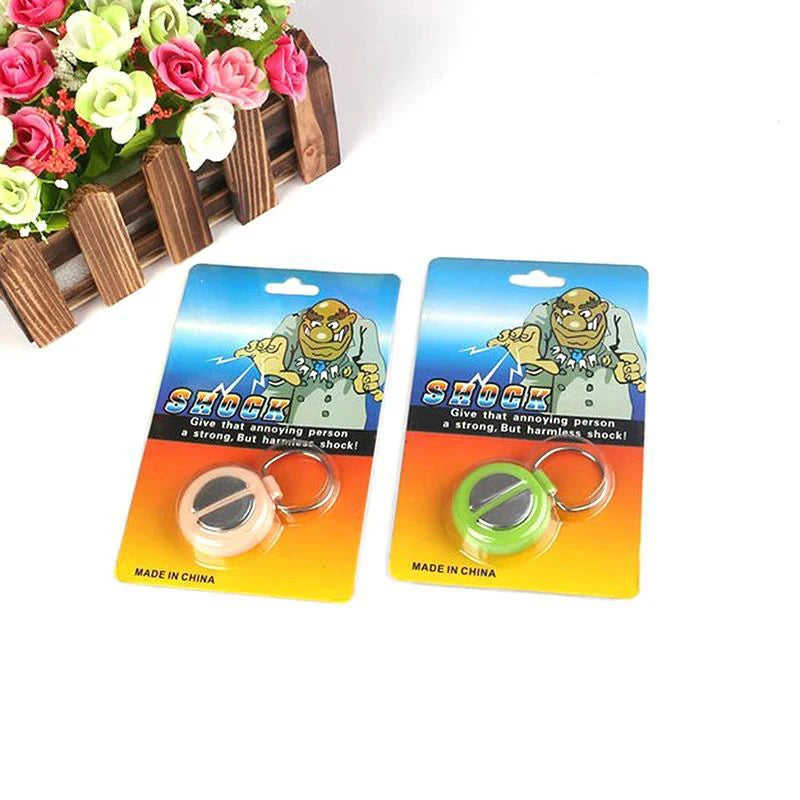 A set of electric shock hand buzzers or prank toys with green and yellow components.