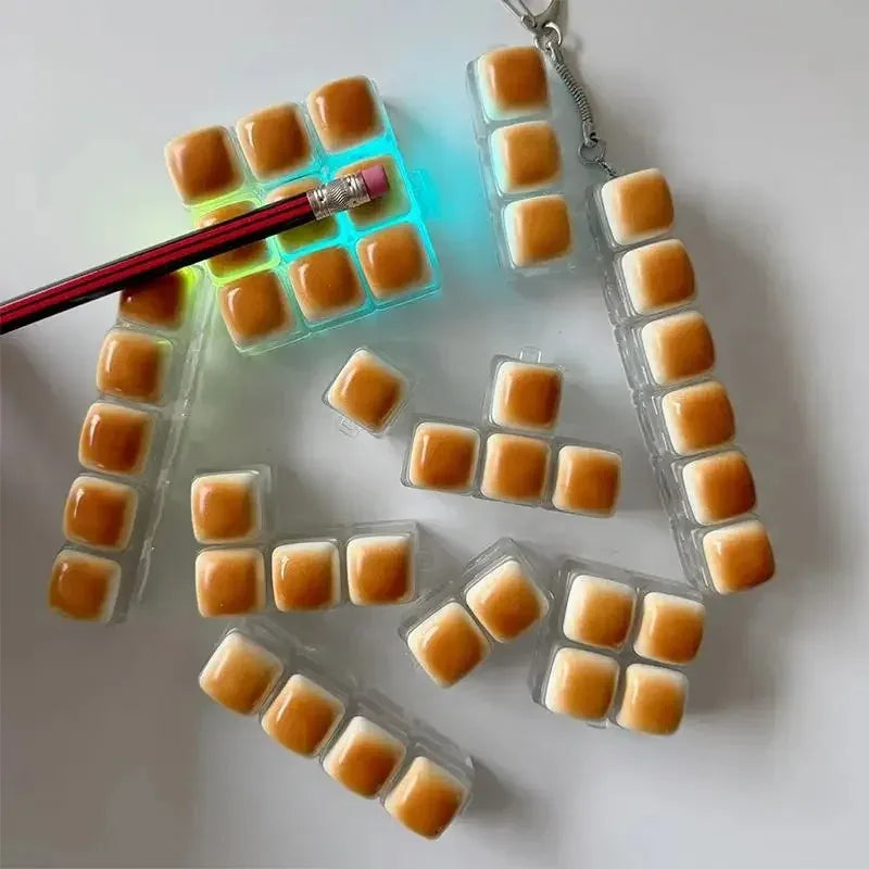 A collection of translucent orange LED mechanical keycaps arranged in various shapes and sizes on a white surface.
