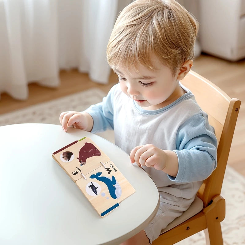 A toddler is interacting with a wooden animal flap book featuring animals like a bear and a dolphin.