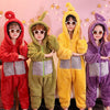 Four children wearing fuzzy, hooded pajamas inspired by Teletubbies characters in red, green, yellow, and purple.