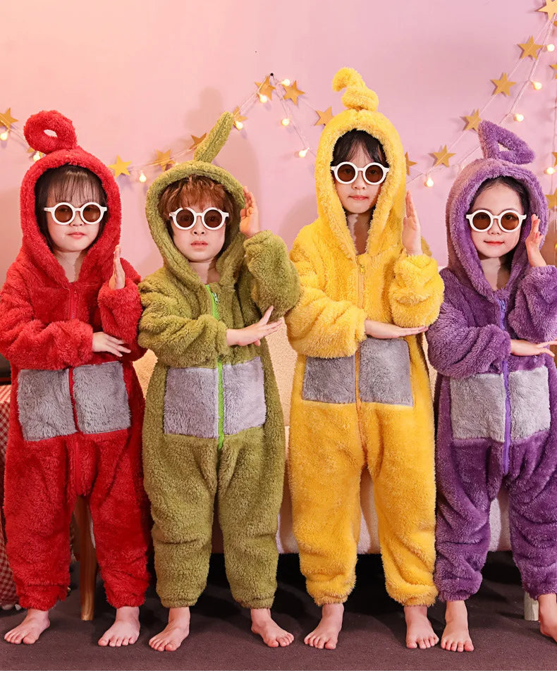 Four children wearing fuzzy, hooded pajamas inspired by Teletubbies characters in red, green, yellow, and purple.