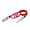 Red professional XLR to 6.35mm audio cable coiled and terminated with a connector.