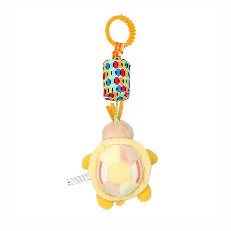 A plush hanging rattle toy with an orange loop and a yellow, round body.