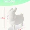 A white plush rabbit stuffed toy with long ears and a small smile, shown in profile.
