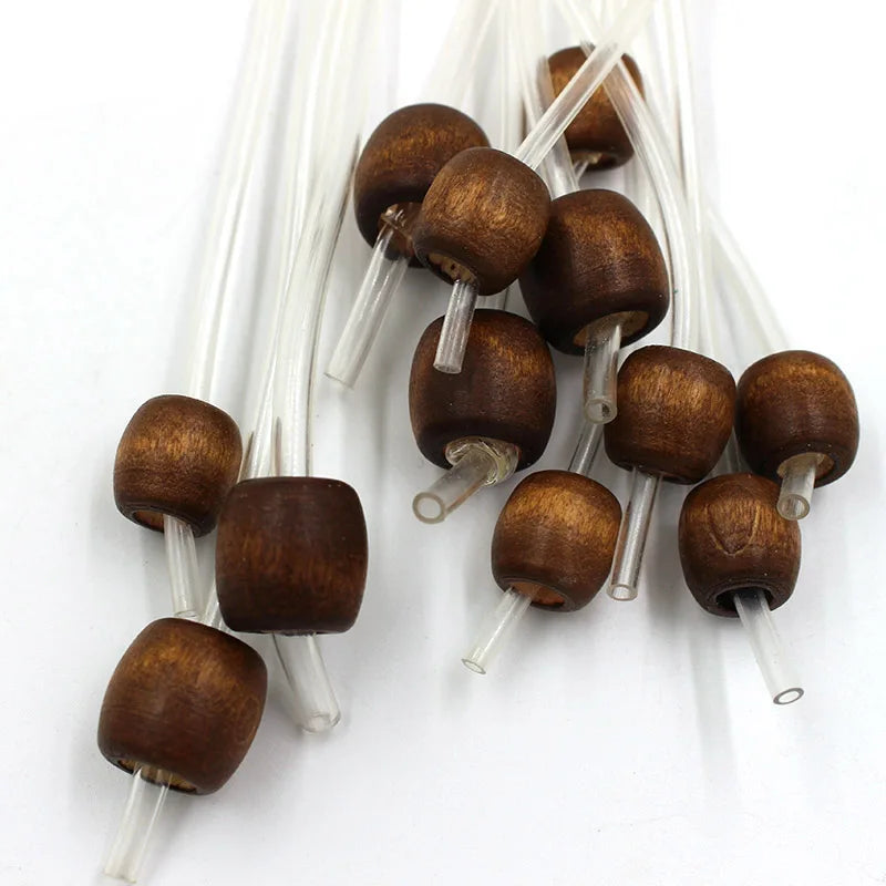 A set of flexible bamboo Tunisian crochet hooks in various sizes and shades of brown wood.