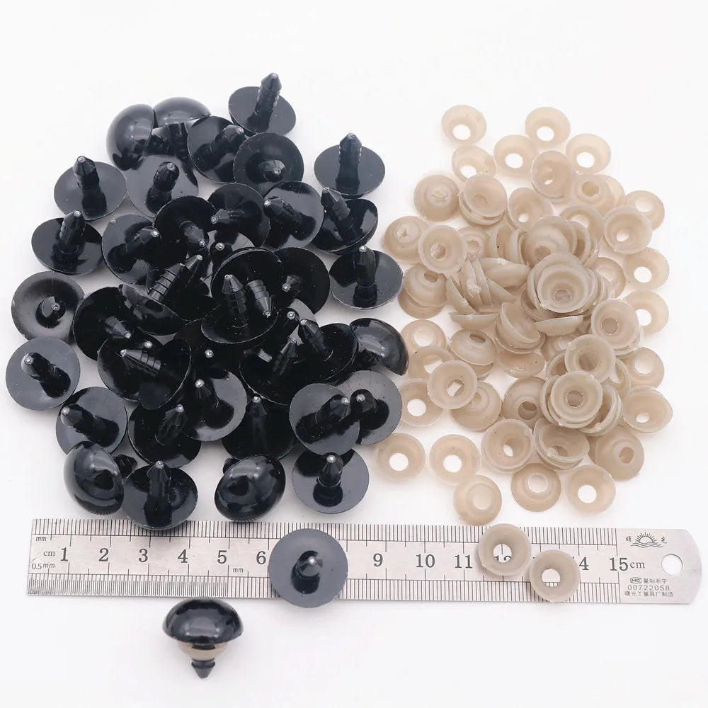 A collection of black and beige plastic safety eyes for amigurumi, including various sizes and locking washers.