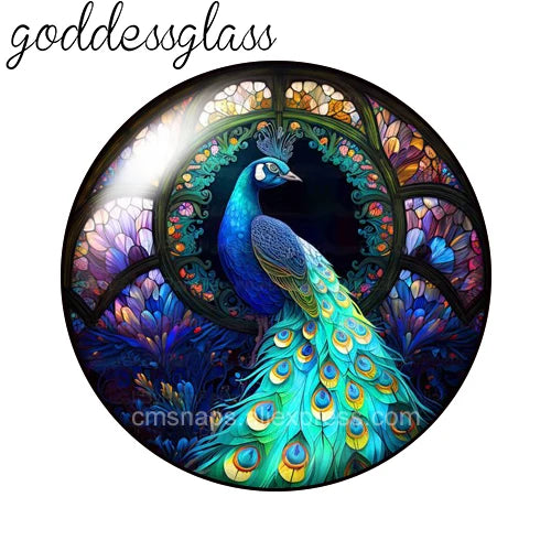 A round glass cabochon featuring a vibrant blue peacock with iridescent green and gold feathers set in an ornate floral backg