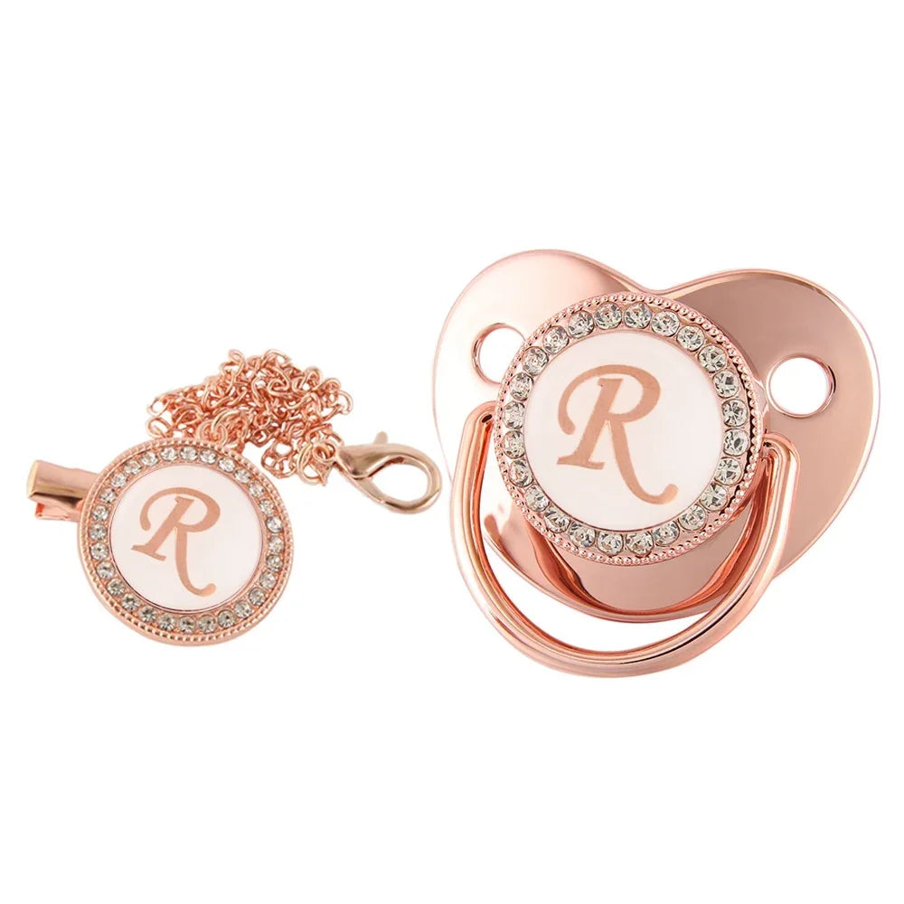 Rose gold bling baby pacifier clip featuring a silicone holder and a decorative rose gold design.