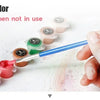 A hand dips a paintbrush in various colors to cover a map, demonstrating the product's use.