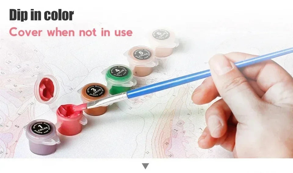 A hand dips a paintbrush in various colors to cover a map, demonstrating the product's use.