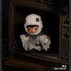 A plush doll resembling a character with black hair and a white hood is displayed in a wooden box.