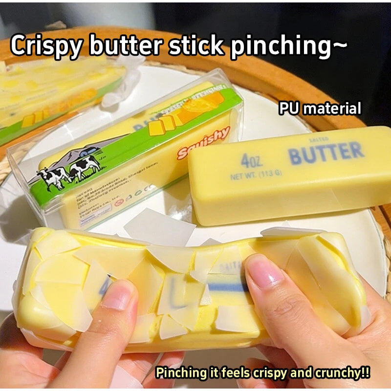 Hands pinch a yellow butter stick made of PU material for a crispy and crunchy feeling