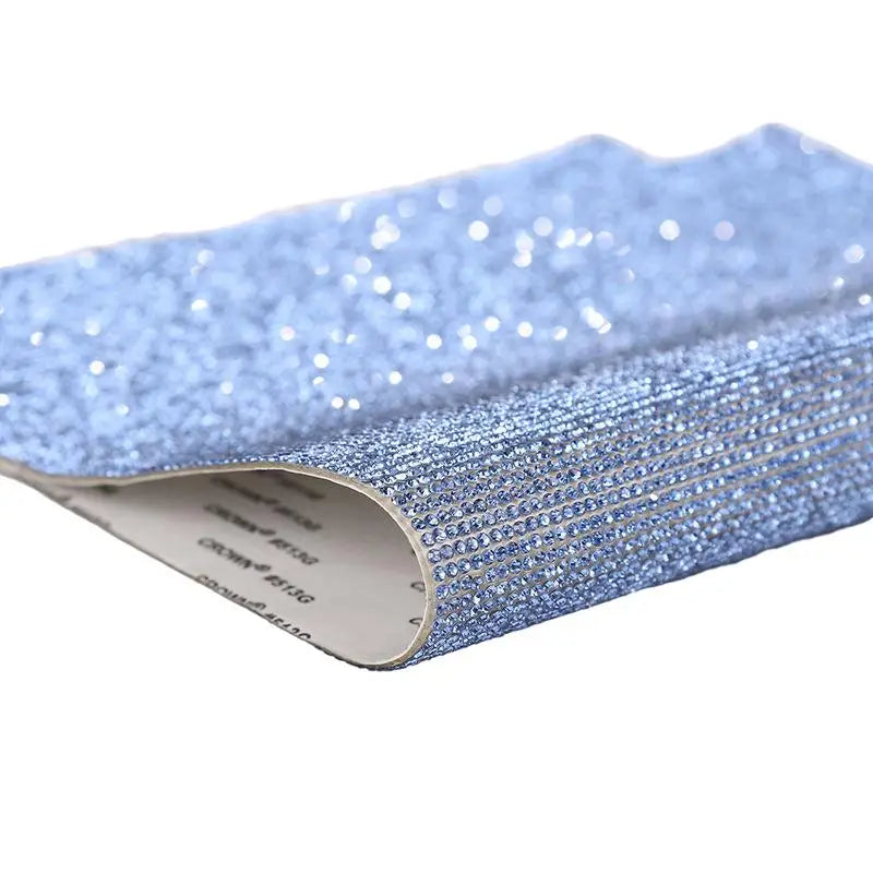 Blue sparkling rhinestone adhesive tape rolled up for DIY crafts and decor