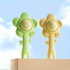 A pair of light green and yellow sensory teething rattles for babies displayed on a white surface.