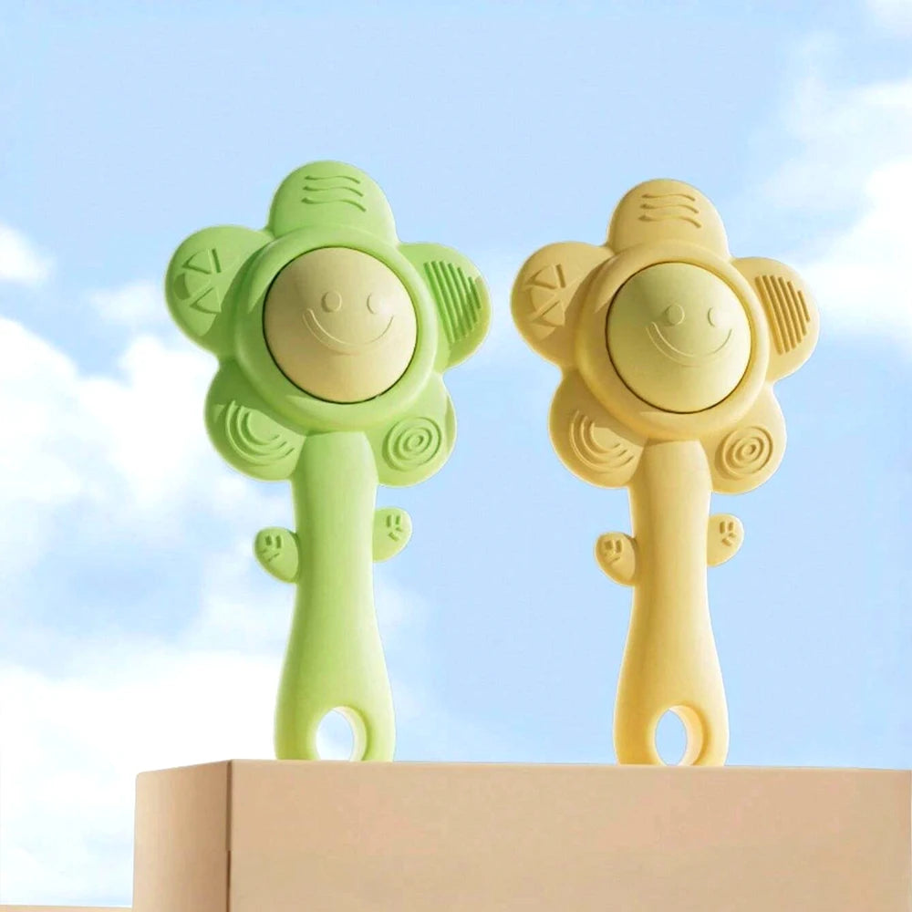 A pair of light green and yellow sensory teething rattles for babies displayed on a white surface.
