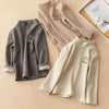 A beige long sleeve t-shirt with a small bear embroidery displayed next to a gray fleece shirt.