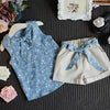 A light blue floral chiffon sleeveless top and matching shorts set for girls displayed on a dark gray fabric.