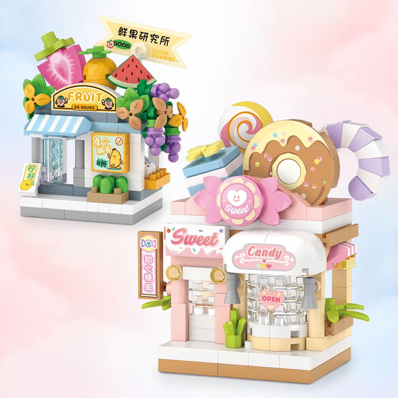 A mini city shop building block set featuring a fruit stand and a candy shop with pink and yellow elements.