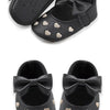 Pair of black baby girl bow-knot first walker shoes with gold heart accents and a soft anti-slip sole