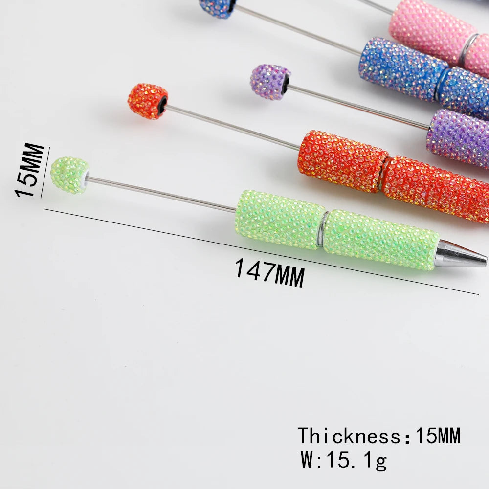A collection of colorful rhinestone pen blanks with various colors and finishes shown against a white background.