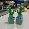 Two green frog figures on light green bases with blue LED lights