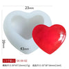 White silicone mold shaped like a heart with a red heart component, used for DIY crafts.