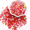 A small white bowl filled with red and pink polymer clay sprinkles for slime decor and DIY craft accents