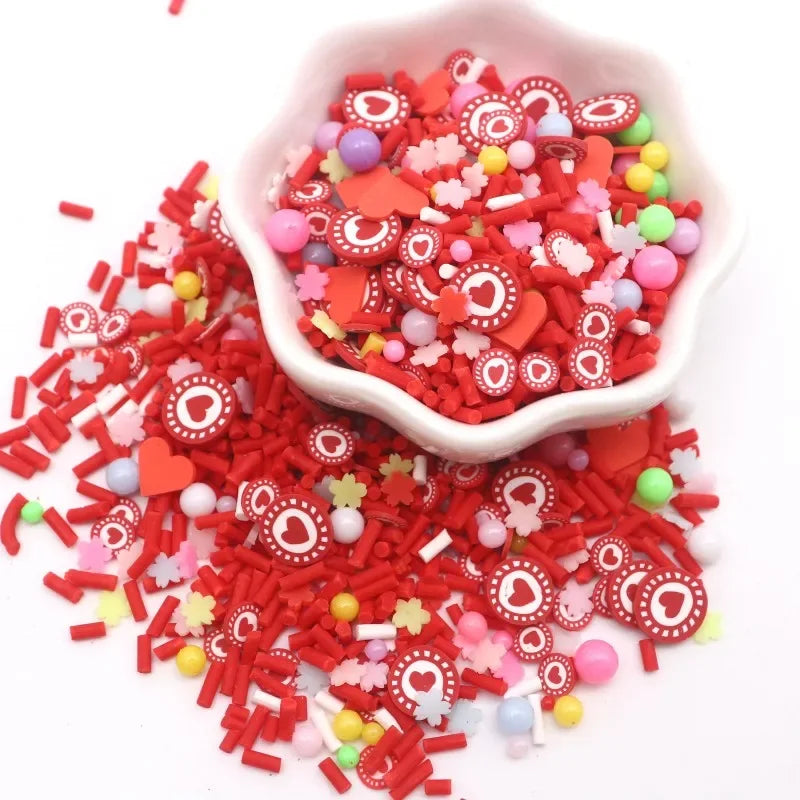 A small white bowl filled with red and pink polymer clay sprinkles for slime decor and DIY craft accents