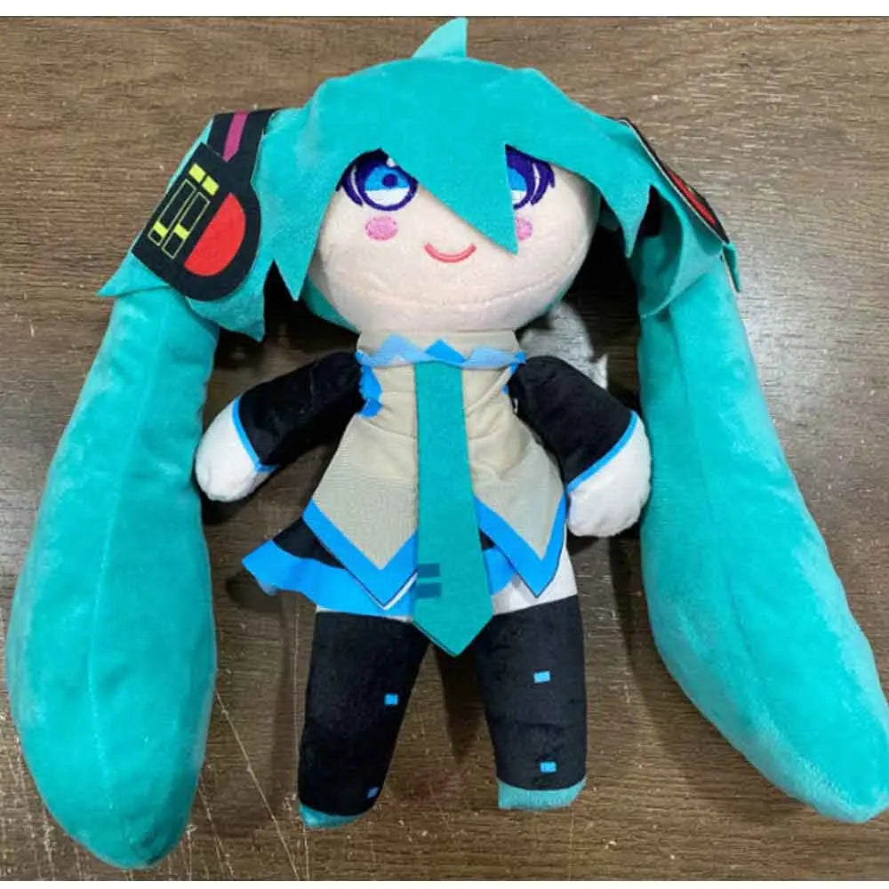 A cute plush doll of Hatsune Miku with teal hair and a blue outfit.