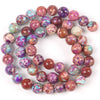 A circular arrangement of natural sea sediment jasper and turquoise beads for jewelry making