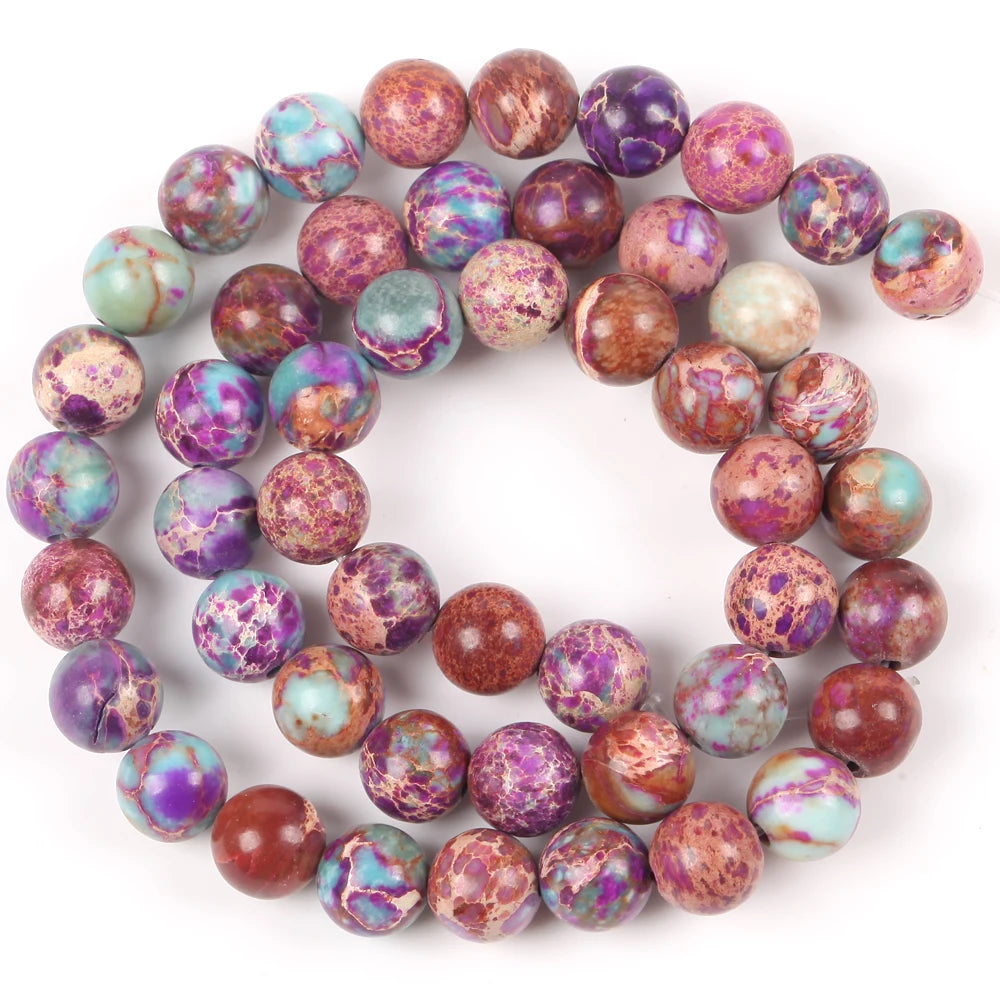 A circular arrangement of natural sea sediment jasper and turquoise beads for jewelry making