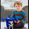 A young boy is holding a blue and black transforming RC robot car toy in a living room setting.