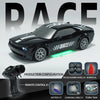 Black racing RC car with a silver hood and green lights, shown alongside its production configuration parts.