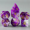 A set of purple and white acrylic dice, including a pyramid shape, for tabletop gaming.