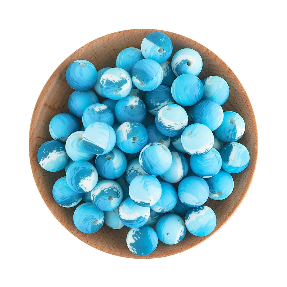 A wooden bowl filled with light blue and white translucent silicone beads for jewelry making