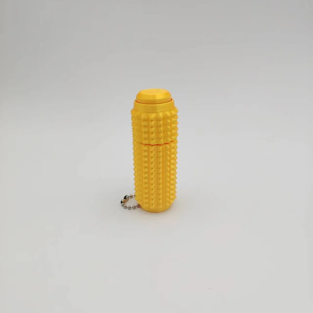 Yellow spiky fidget roller stress relief keychain.
