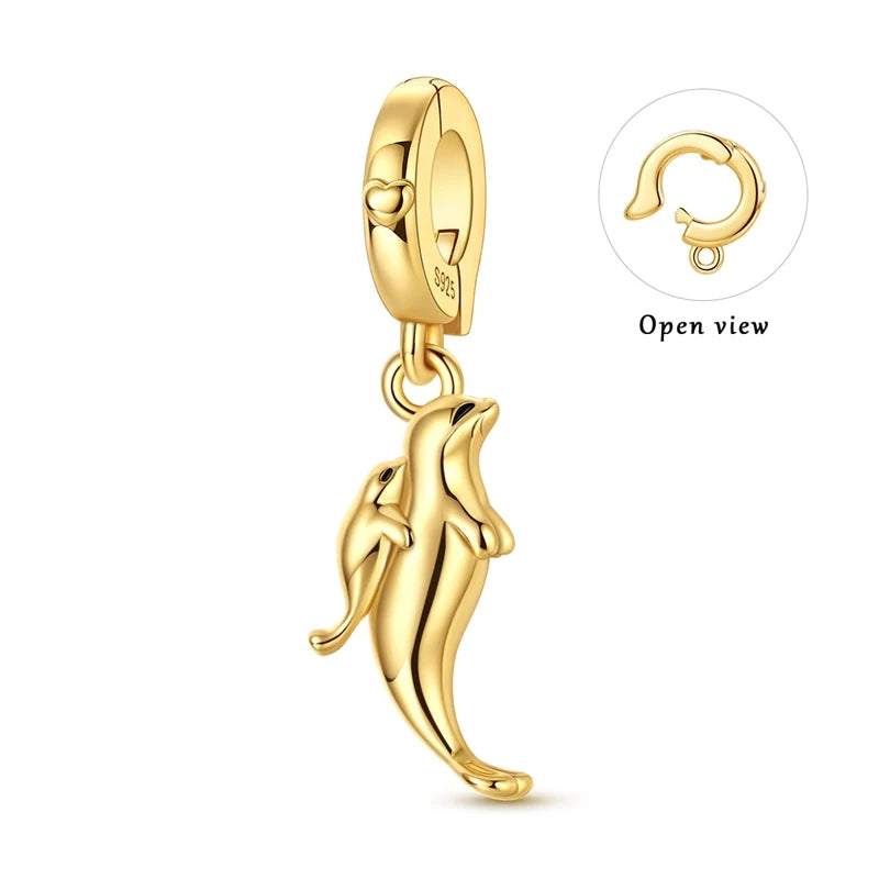 Gold-tone sterling silver charm pendant set featuring starfish, sea turtle, and whale shark figures.