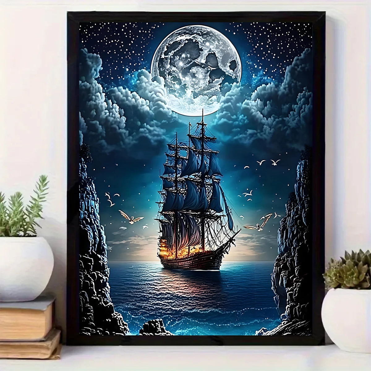 Diamond painting of a pirate ship sailing under a giant moon in a dark night sky