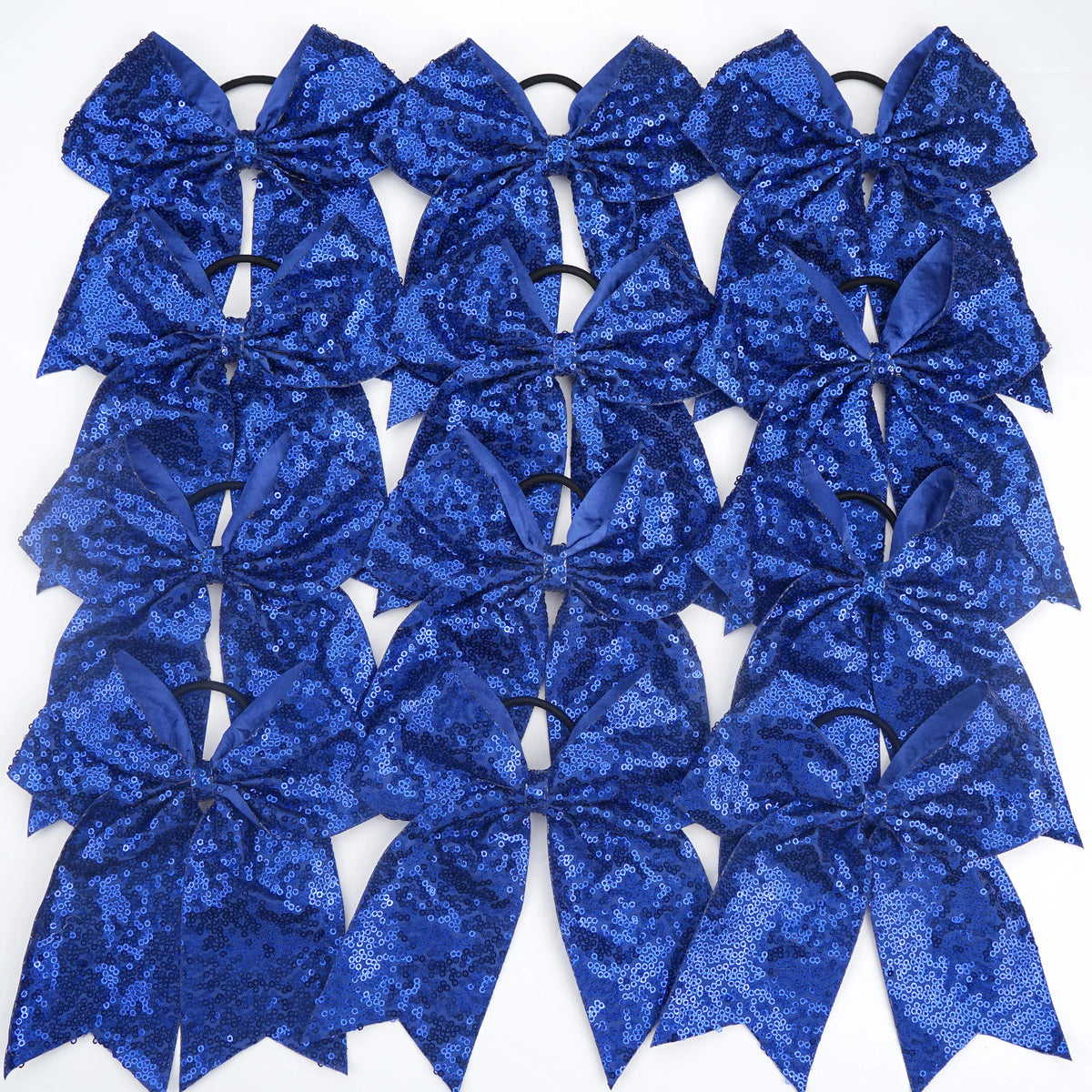 A pack of twelve blue glitter sequin pigtail bows for girls with elastic hair ties.