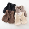 A set of three cozy lamb wool vests in black, brown, and beige shades.