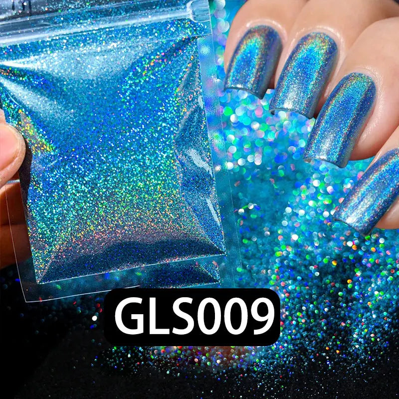 A hand displays iridescent blue holographic nail glitter and fine sparkle dust for DIY nail art.