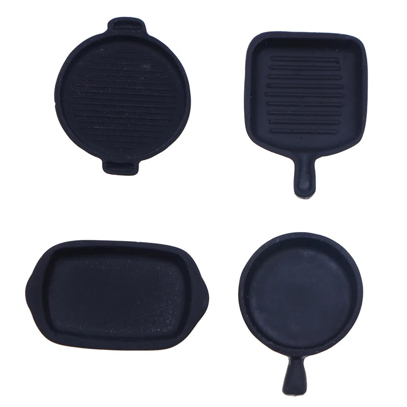Set of four miniature black copper soup pots for a dollhouse kitchen