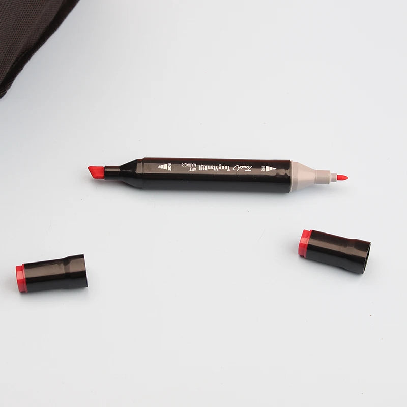 A set of dual-tip alcohol art markers in black and red, showing the marker body and tip.