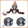A plush toy figure of a monkey with a party hat and a small ball, alongside a black gorilla-like plush.
