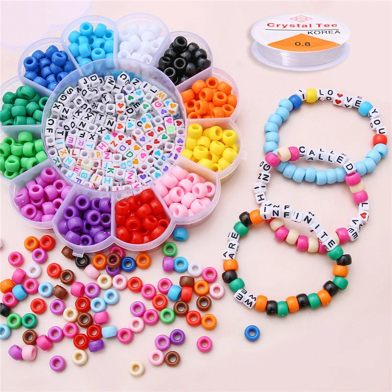 A collection of pony beads in various colors, including letters and various shapes, arranged in plastic containers and strung